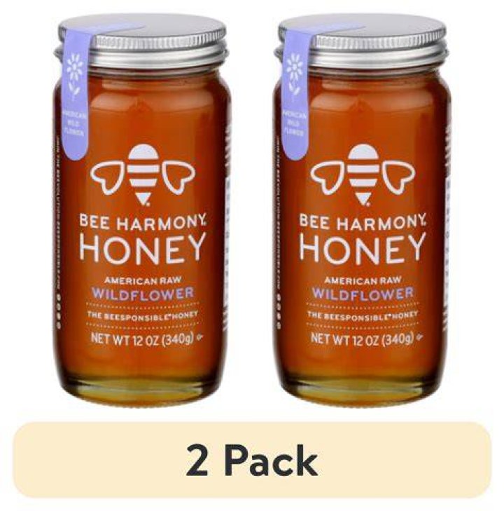 a jar of bee harmony honey on a white background